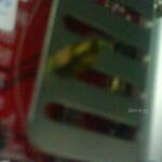 A mounted computer motherboard standoff on a GPU's heatsink's fin.