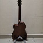 DIY guitar stand with a guitar mounted on it, viewed from behind.