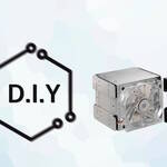 An image with the words D.I.Y and a Cooler Master hard disk cage, over a light blue background.