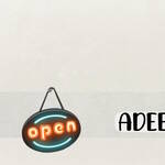 Neon sign, spelling 'open' hanging over the letter e in the wording Adeeology.