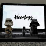 Picture of Adee's laptop, with Darth Vader and a Stormtrooper figurines flanking a Tie Fighter figurine on the keyboard.