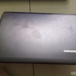 A dirtied top shell of a laptop.